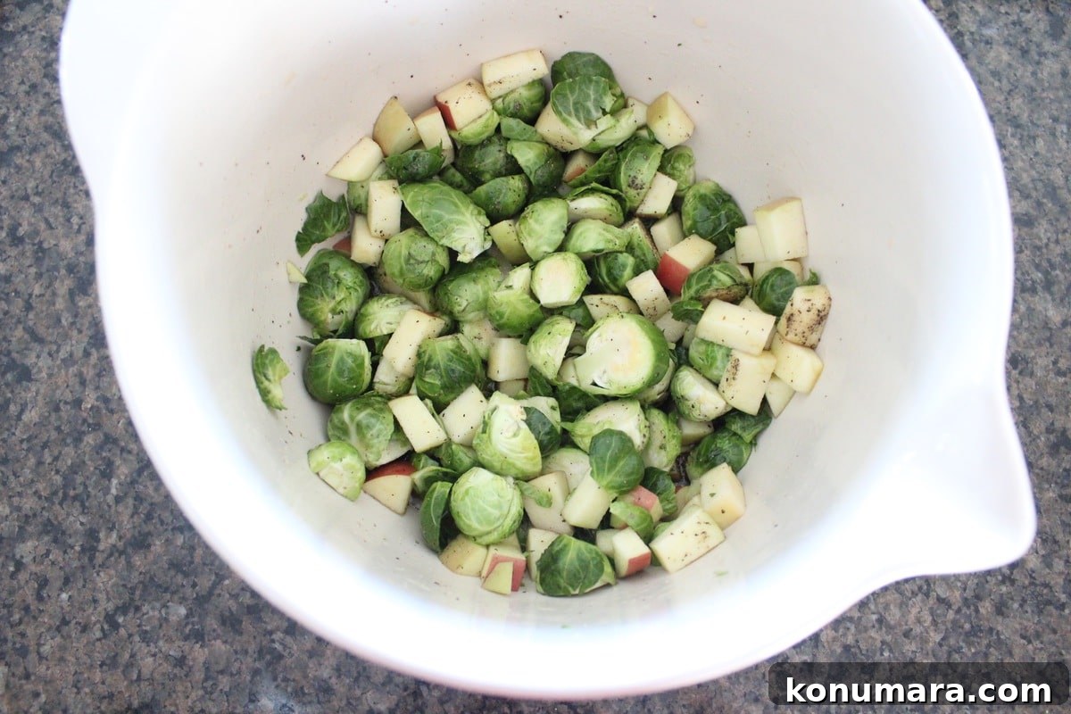 Crispy Maple-Glazed Roasted Brussels Sprouts 4 brussels sprouts and diced apples seasoned in large mixing bowl