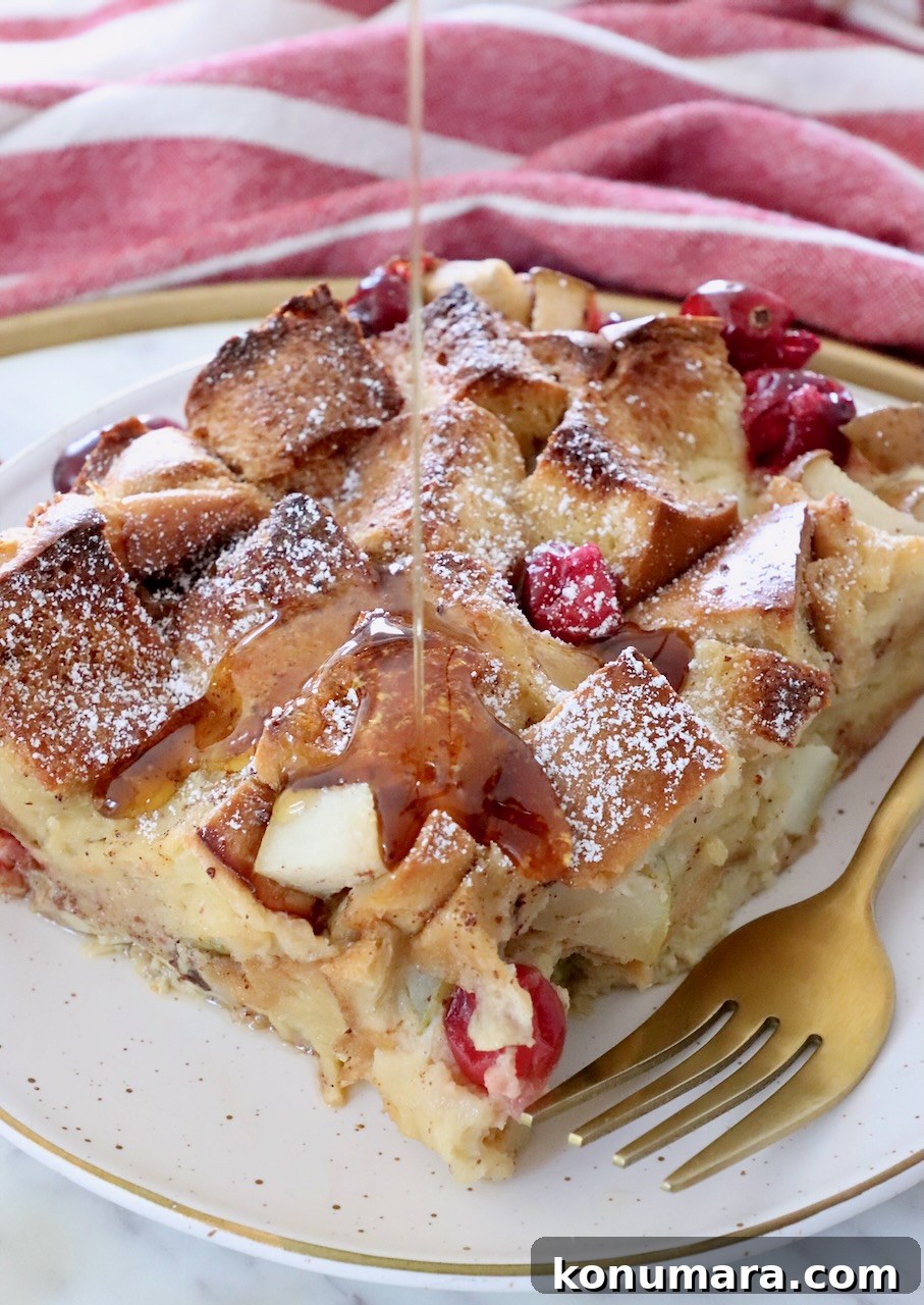 syrup poured over a slice of french toast casserole on a plate with a fork