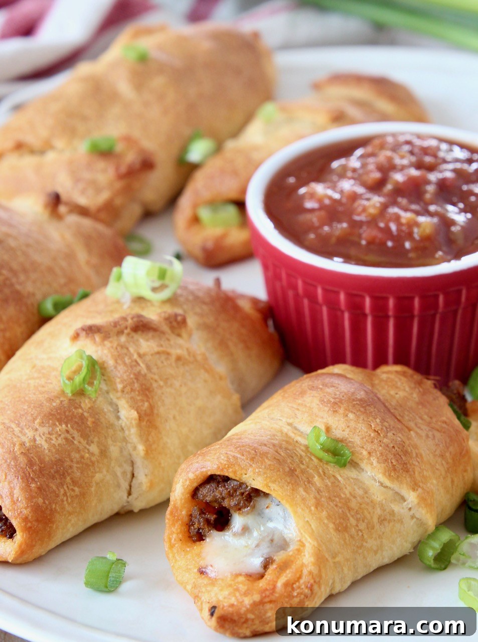 taco crescent rolls on plate with small bowl of salsa