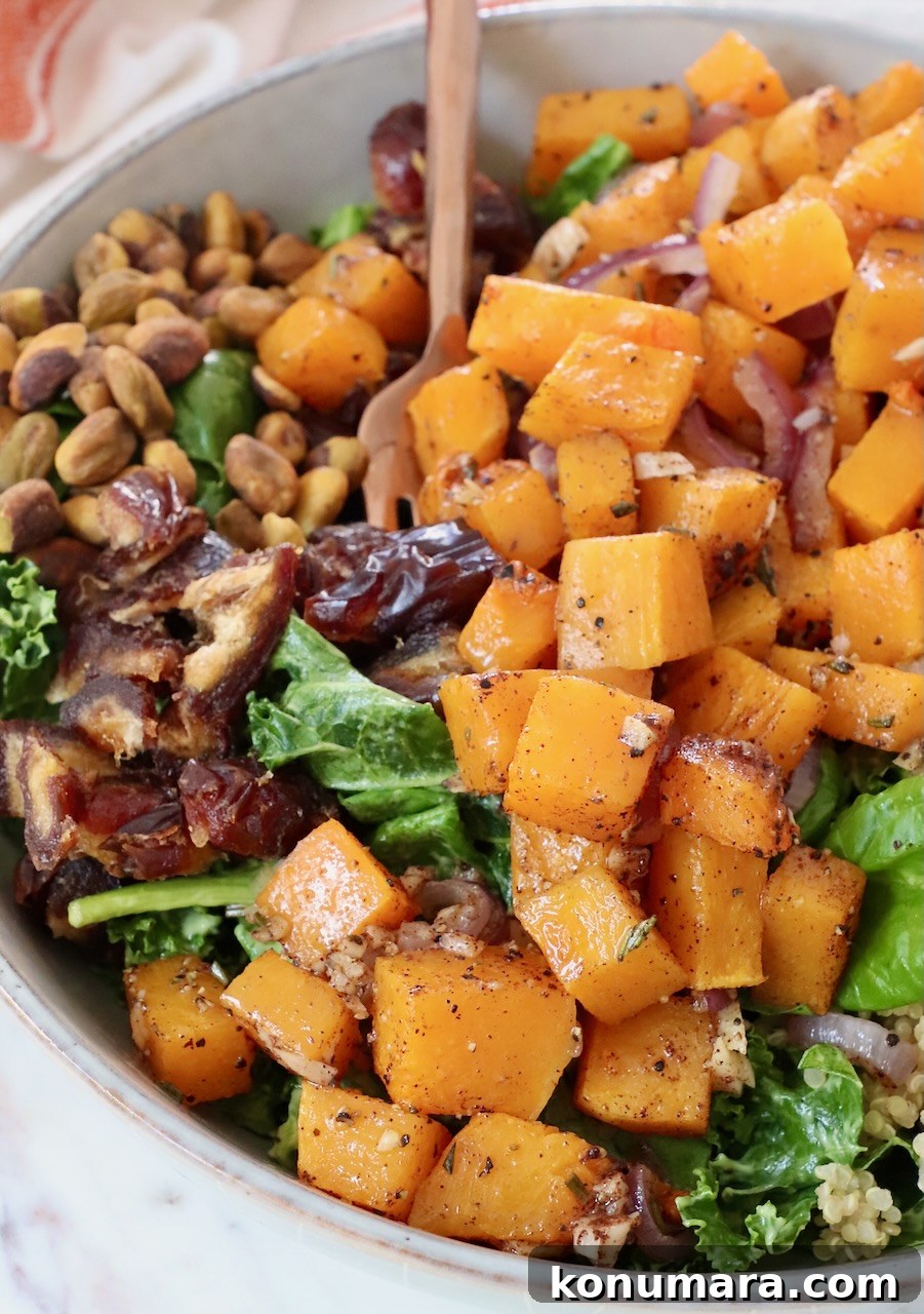 Roasted Butternut Squash Salad with Maple Vinaigrette 9 roasted butternut squash on top of a salad in a bowl
