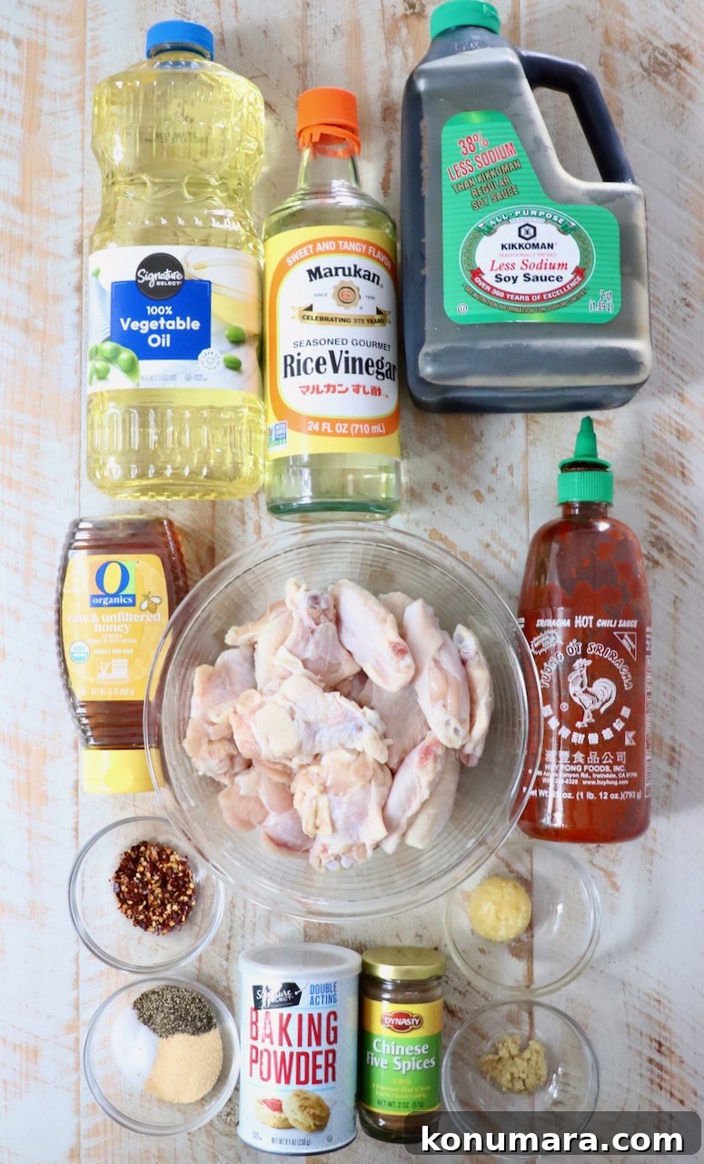 ingredients for general tso chicken wings on a white wood board