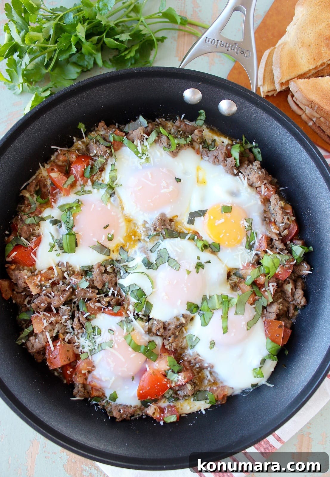 Italian Turkey Breakfast Skillet topped with sunny side up eggs and fresh chopped basil