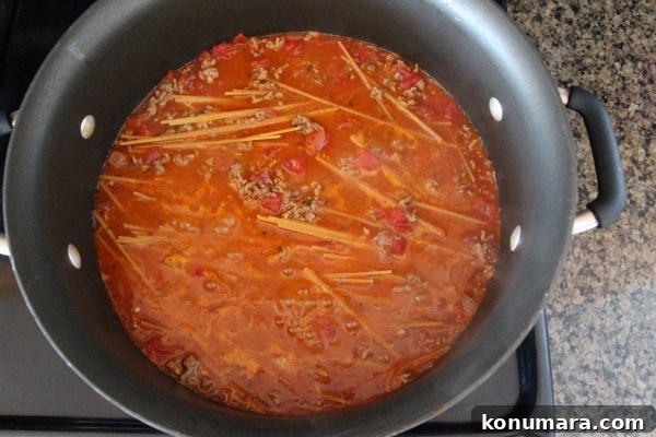 taco spaghetti cooking in a large pot on the stove