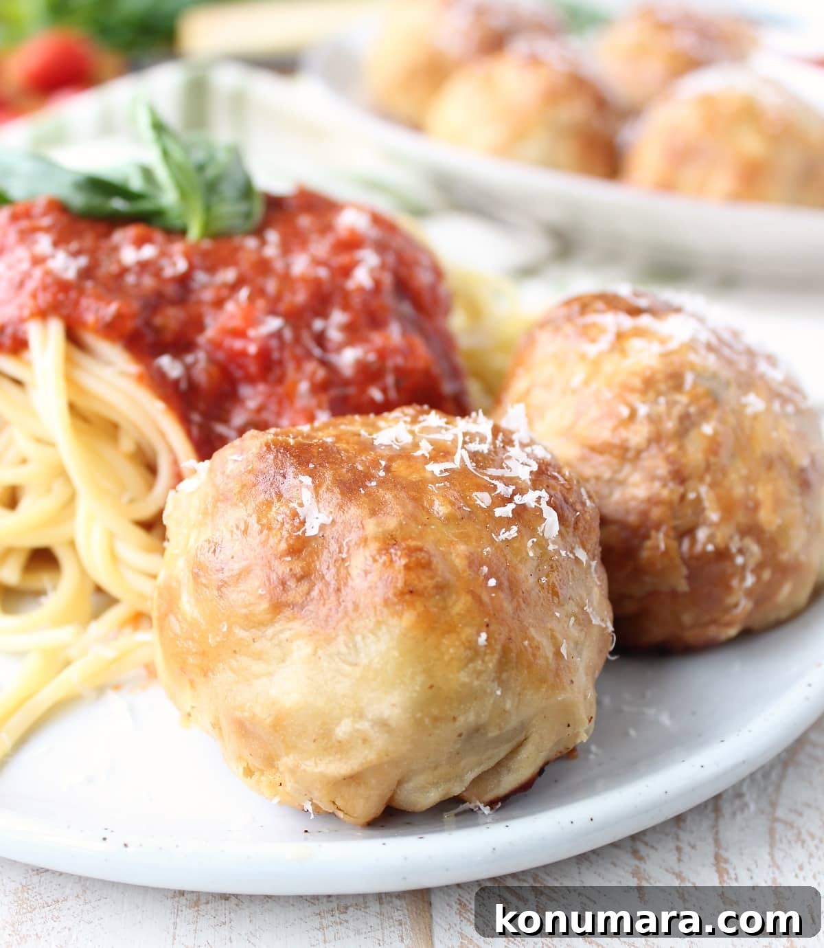 Puff Pastry Wrapped Meatballs on plate with spaghetti and marinara sauce