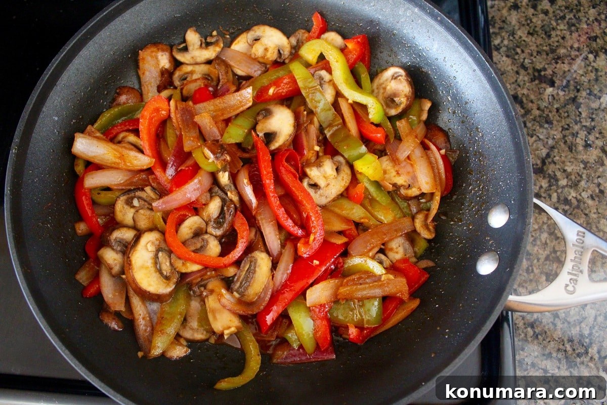 Vegetarian Fajita Rice Bowl with Peppers and Black Beans 4 fajita vegetables in skillet on stove