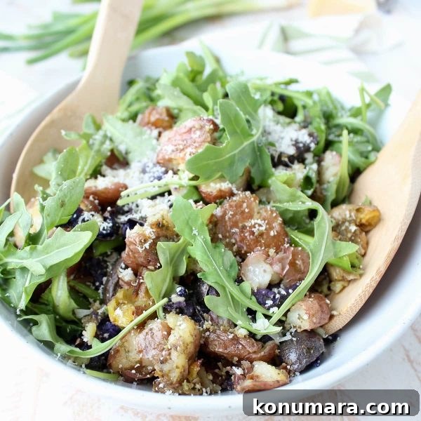 Pesto Smashed Potato Salad Recipe 3 Close up of pesto smashed potato salad with grated parmesan
