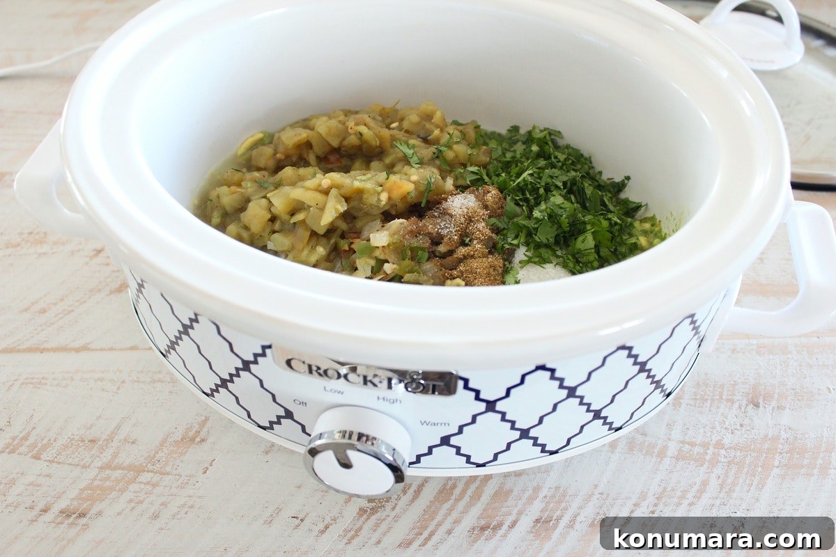 Diced green chilies, cilantro and spices in crock pot