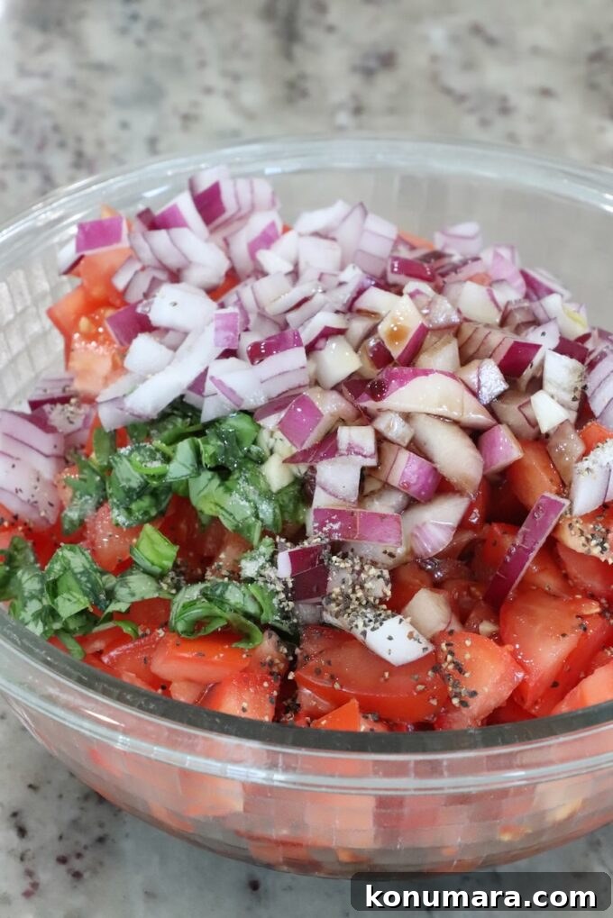 Bruschetta Chicken Recipe with Basil and Balsamic Glaze 4 diced tomatoes, onions and basil in a glass bowl