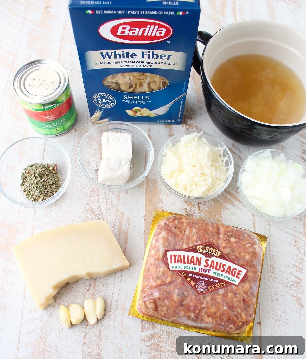 Italian Sausage Shells and Cheese Ingredients on a white wood board