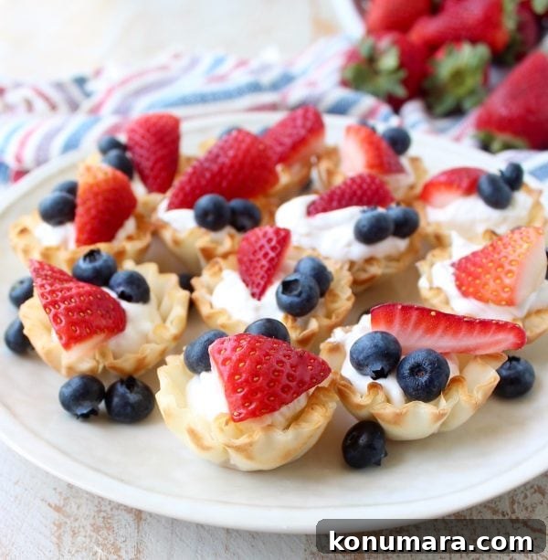Stacked berry cream fillo baskets showing layers and fresh garnish