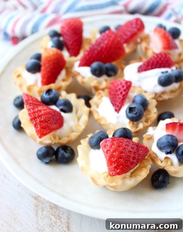 Mini fillo baskets filled with creamy mixture and topped with fresh berries