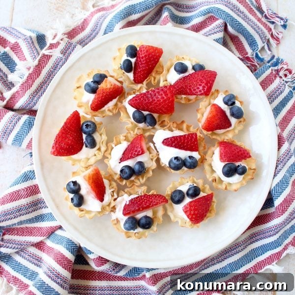 Tray of finished berry cream fillo baskets ready for a summer party
