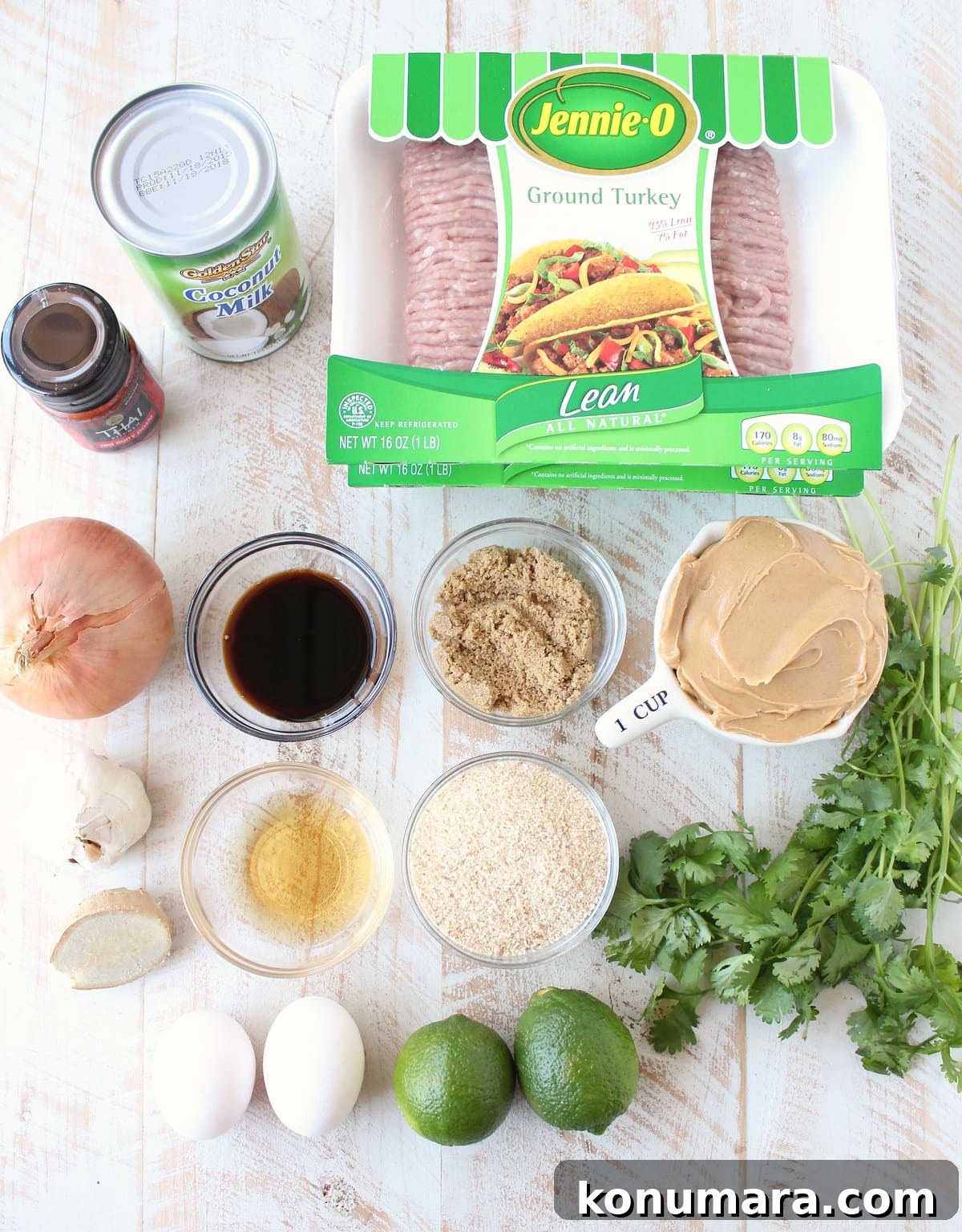 ingredients for thai turkey meatballs on a white wood board