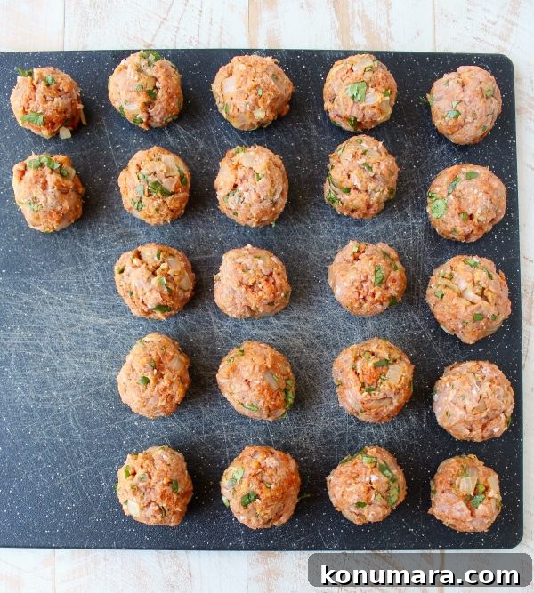 uncooked turkey meatballs on a cutting board