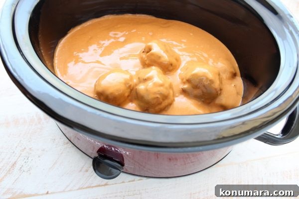 turkey meatballs covered in peanut sauce in a slow cooker