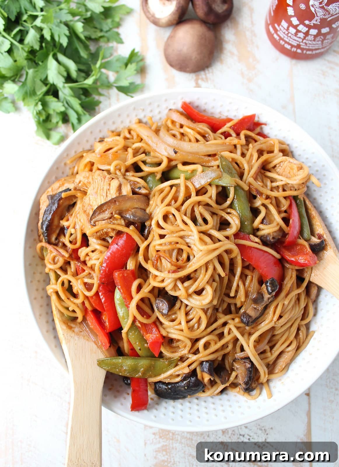 Chicken Lo Mein Recipe: Quick Weeknight Stir Fry 2 prepared chicken lo mein with vegetables in a bowl with serving spoons