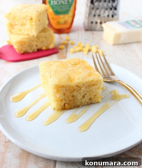A warm slice of slow cooker cornbread with butter
