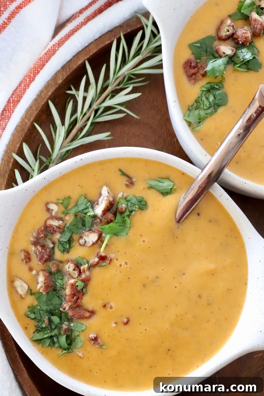 Creamy Roasted Sweet Potato Soup Recipe 2 sweet potato soup in bowls with a spoon