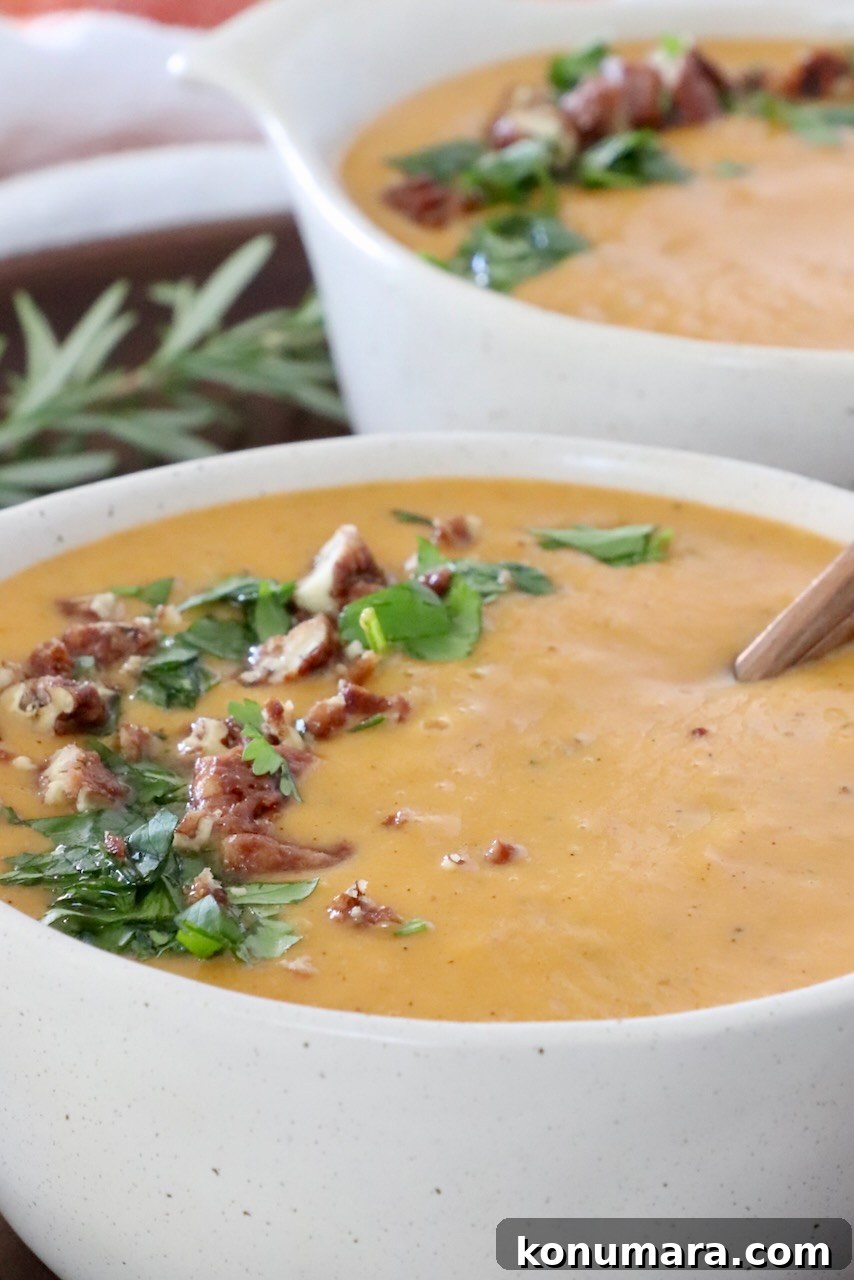 Creamy Roasted Sweet Potato Soup Recipe 5 sweet potato soup in bowls topped with chopped parsley and nuts