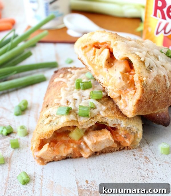Cheesy Buffalo Chicken Bake Recipe 7 Two halves of a buffalo chicken bake stacked together on a wooden surface.