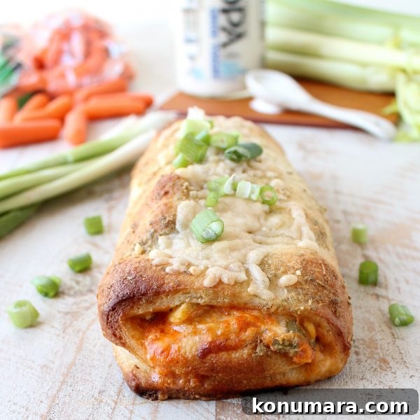 Cheesy Buffalo Chicken Bake Recipe 8 Buffalo Chicken Bake on a wooden surface garnished with green onions.