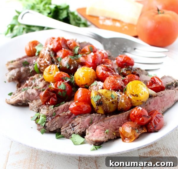 Sliced flank steak with roasted tomatoes and parmesan