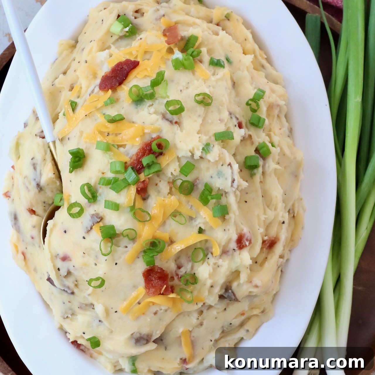 15 Thanksgiving Recipes to Impress Your Holiday Guests 5 loaded mashed potatoes in serving dish with spoon