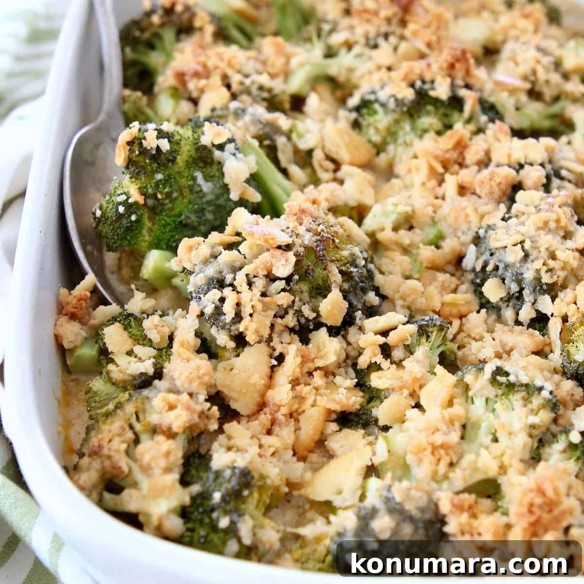 15 Thanksgiving Recipes to Impress Your Holiday Guests 6 broccoli casserole with ritz cracker topping in dish with serving spoon