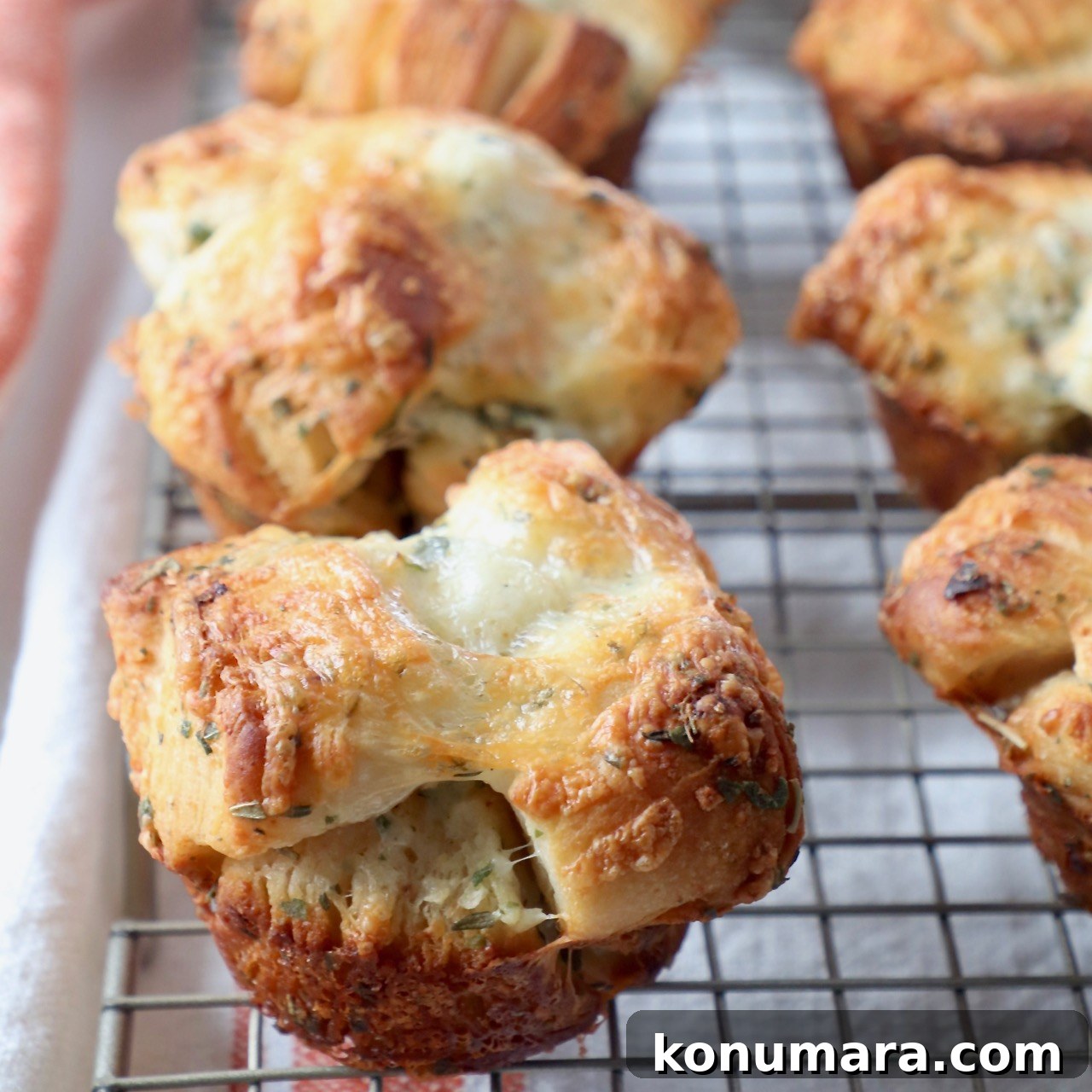 15 Thanksgiving Recipes to Impress Your Holiday Guests 10 baked pull apart rolls sitting on wire cooling rack