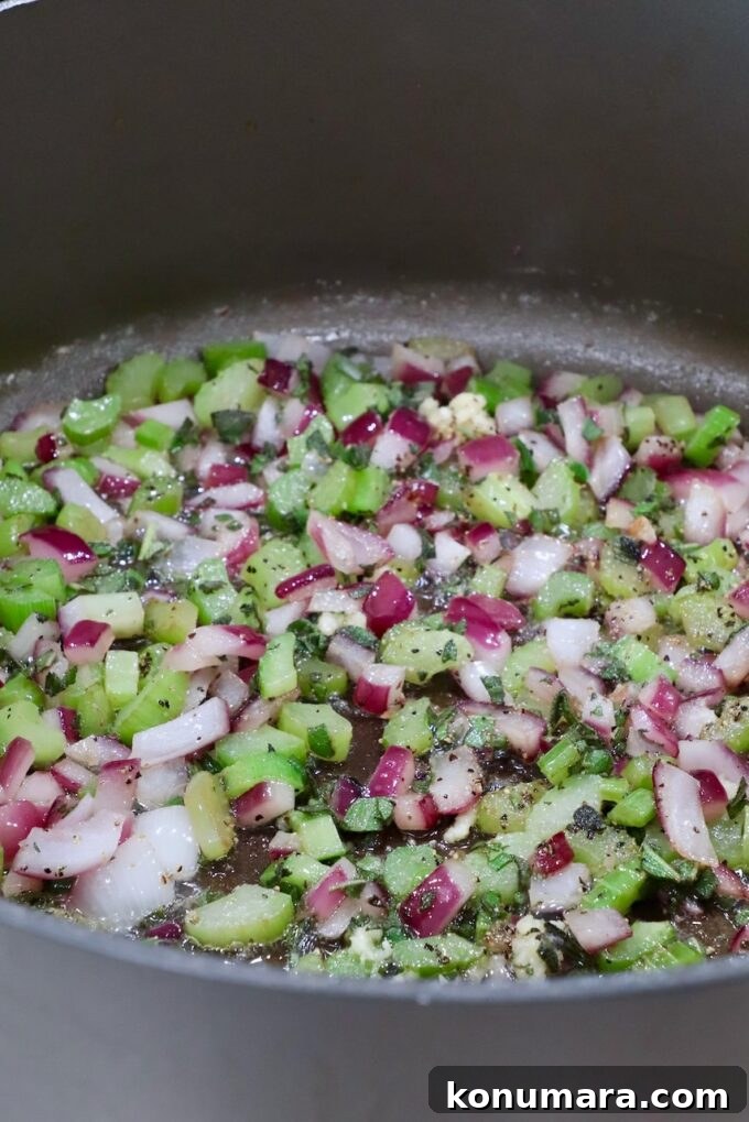Savory Sausage Stuffing Recipe with Herbs 5 diced onion and celery with seasonings in a large pan