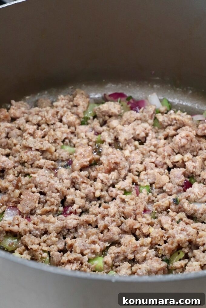 Savory Sausage Stuffing Recipe with Herbs 6 cooked, crumbled pork sausage in a large pan with diced vegetables