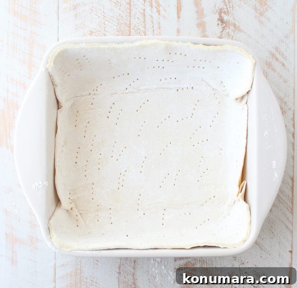 puff pastry dough pressed into a square baking dish