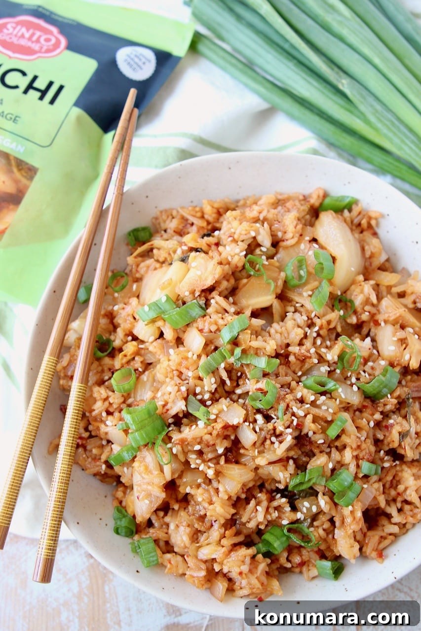 Overhead shot of Kimchi Fried Rice in bowl with chopsticks