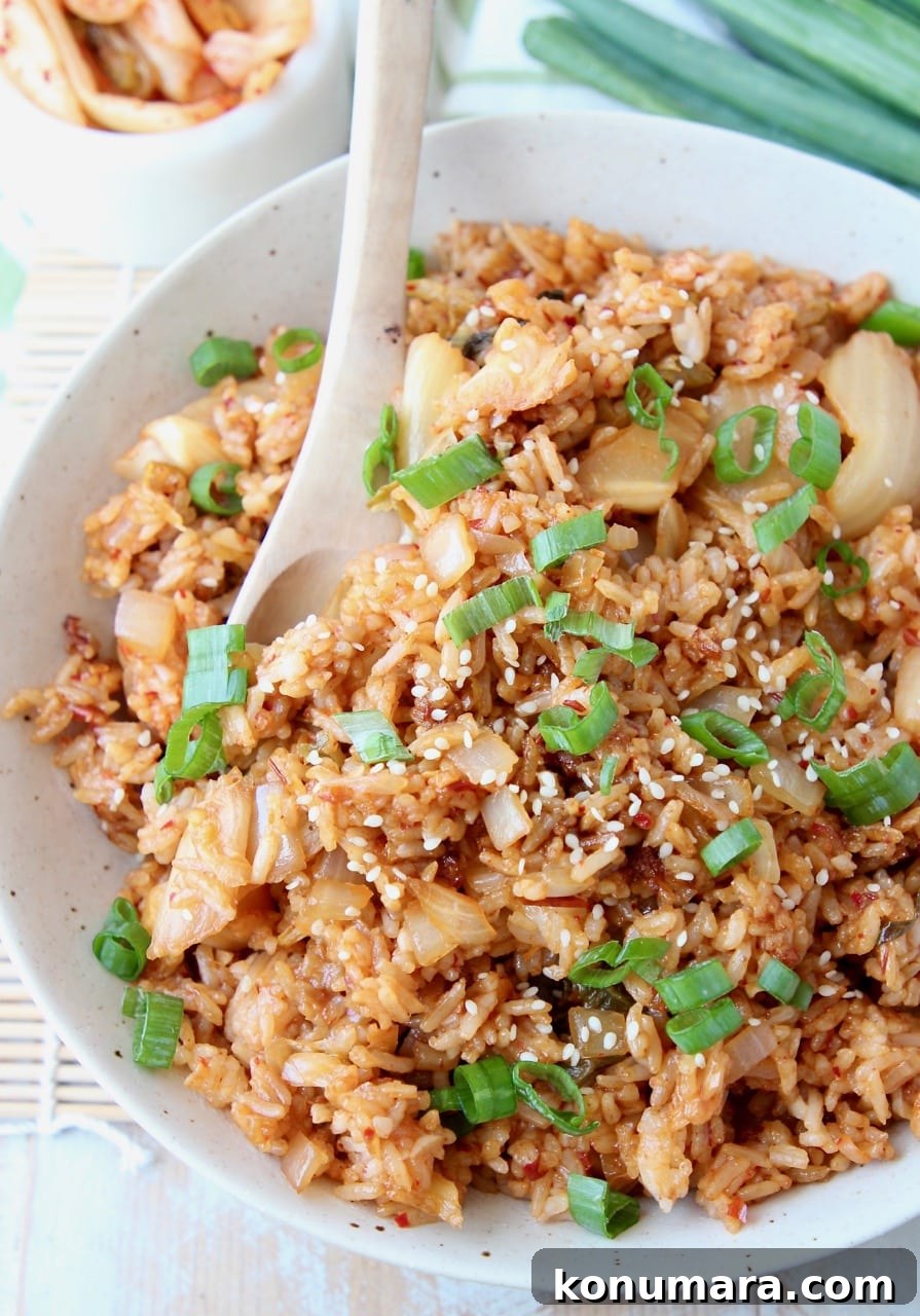 Overhead shot of kimchi fried rice in bowl with spoon