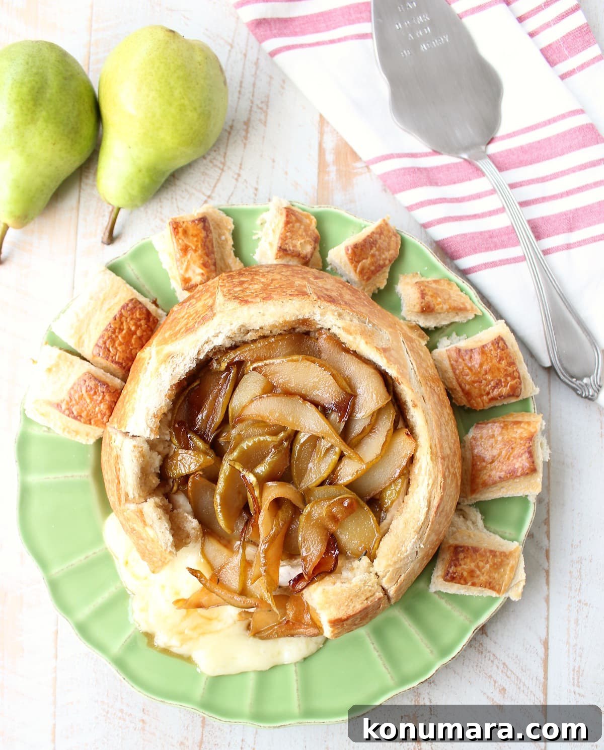 Baked brie bread bowl with caramelized Bartlett pears