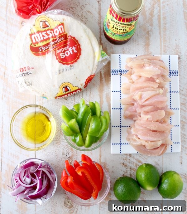 Platter of jerk chicken fajitas with colorful peppers and lime wedges