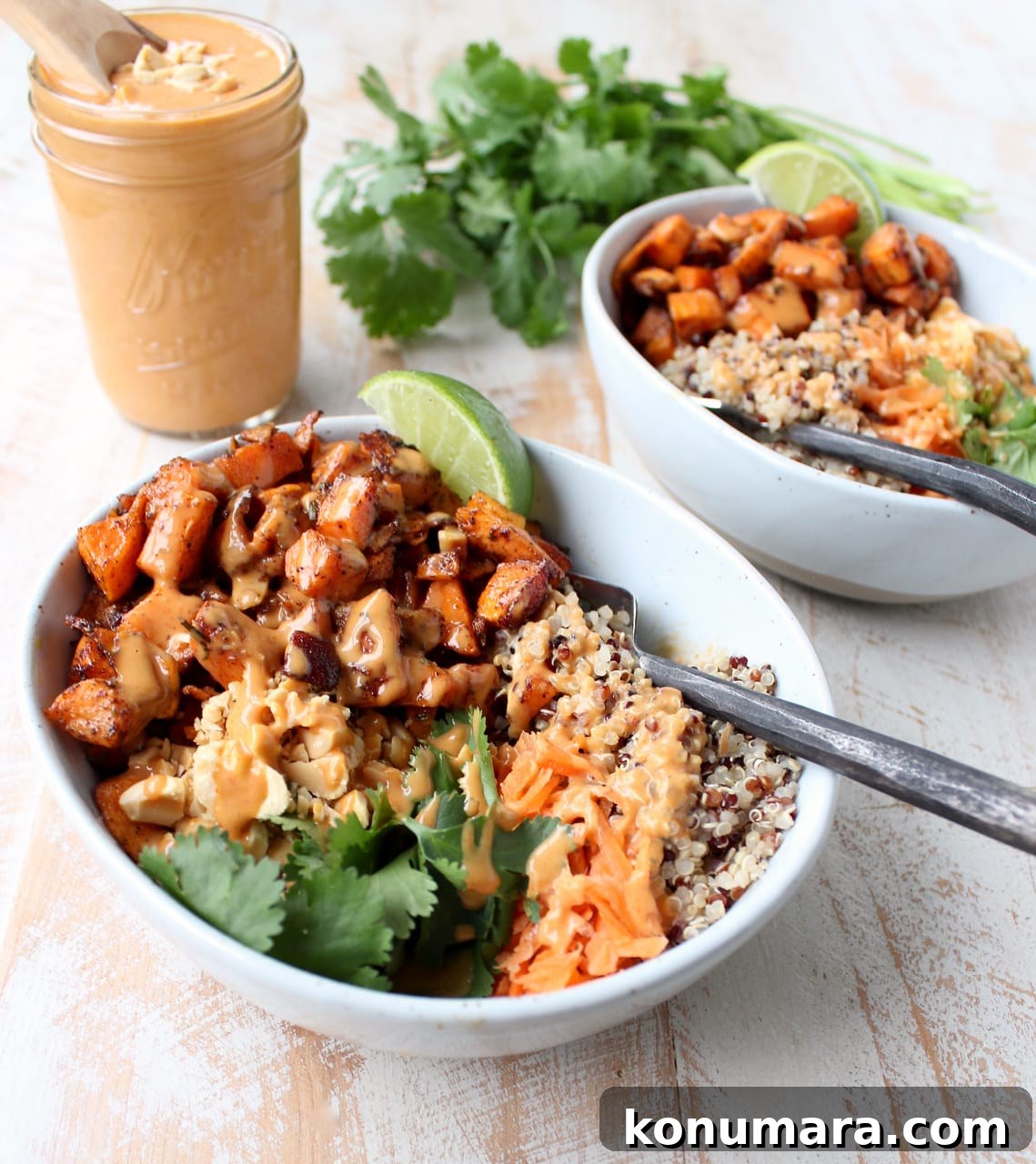 Thai Peanut Sweet Potato Buddha Bowl Recipe 2 Roasted sweet potatoes in bowls with quinoa, shredded carrots and cilantro