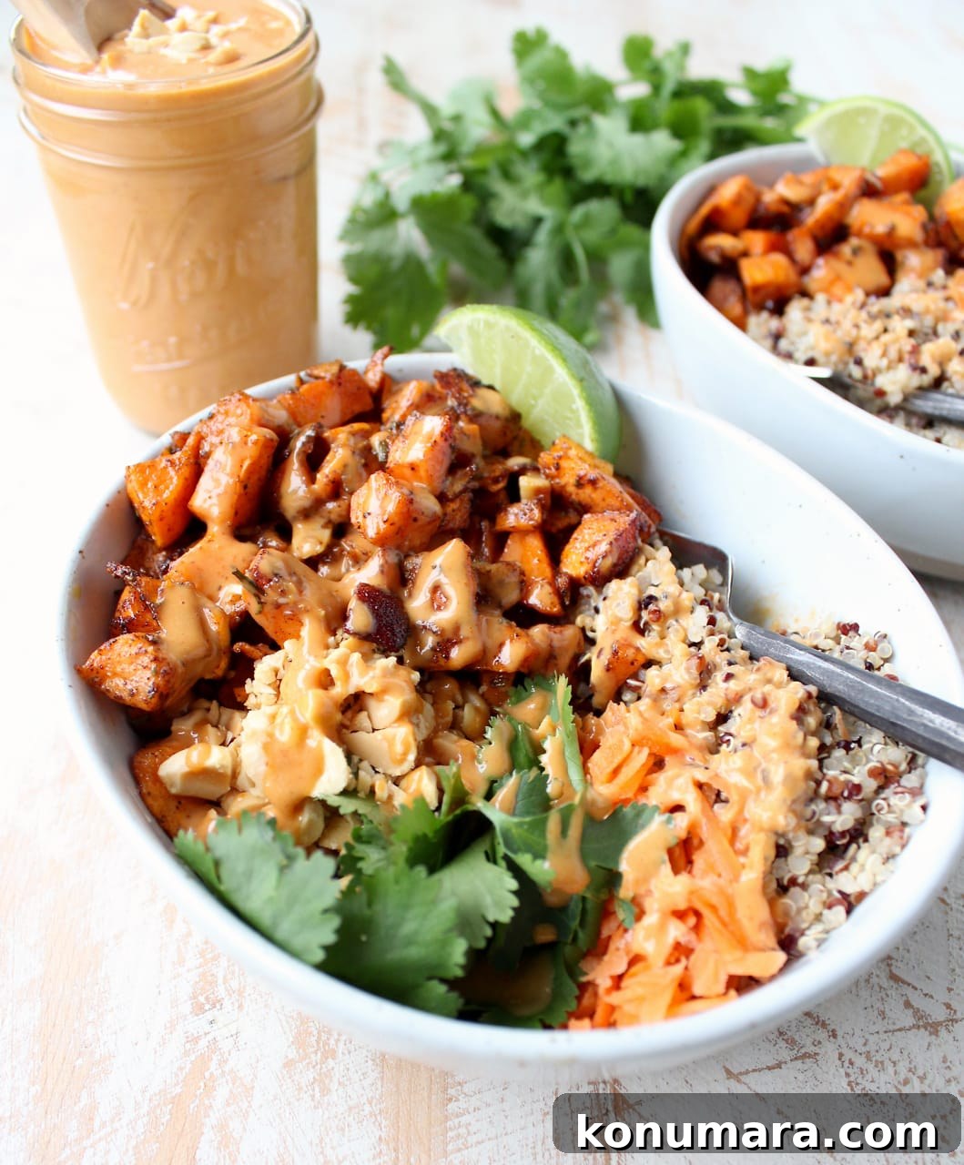 Thai Peanut Sweet Potato Buddha Bowl Recipe 5 Roasted diced sweet potatoes in bowl with quinoa and thai peanut sauce