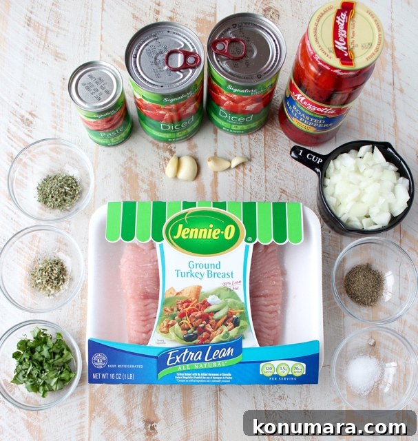 ingredients for turkey bolognese on a white wood board