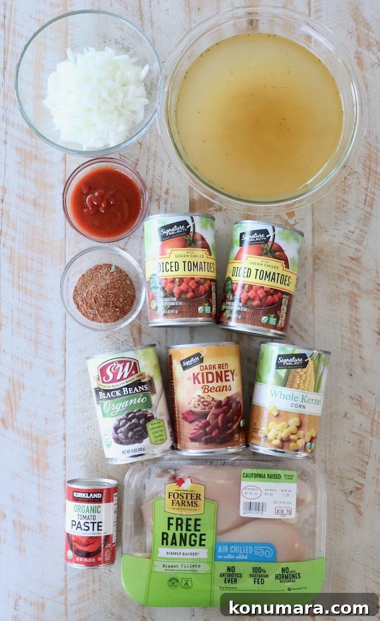Creamy Slow Cooker Chicken Enchilada Soup 3 ingredients for chicken enchilada soup on white wood board