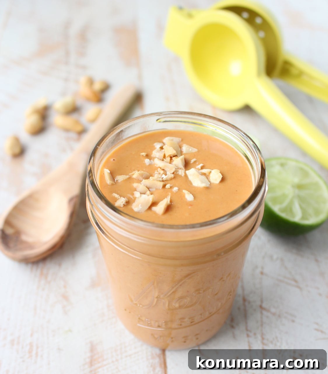 peanut sauce in a mason jar topped with chopped peanuts
