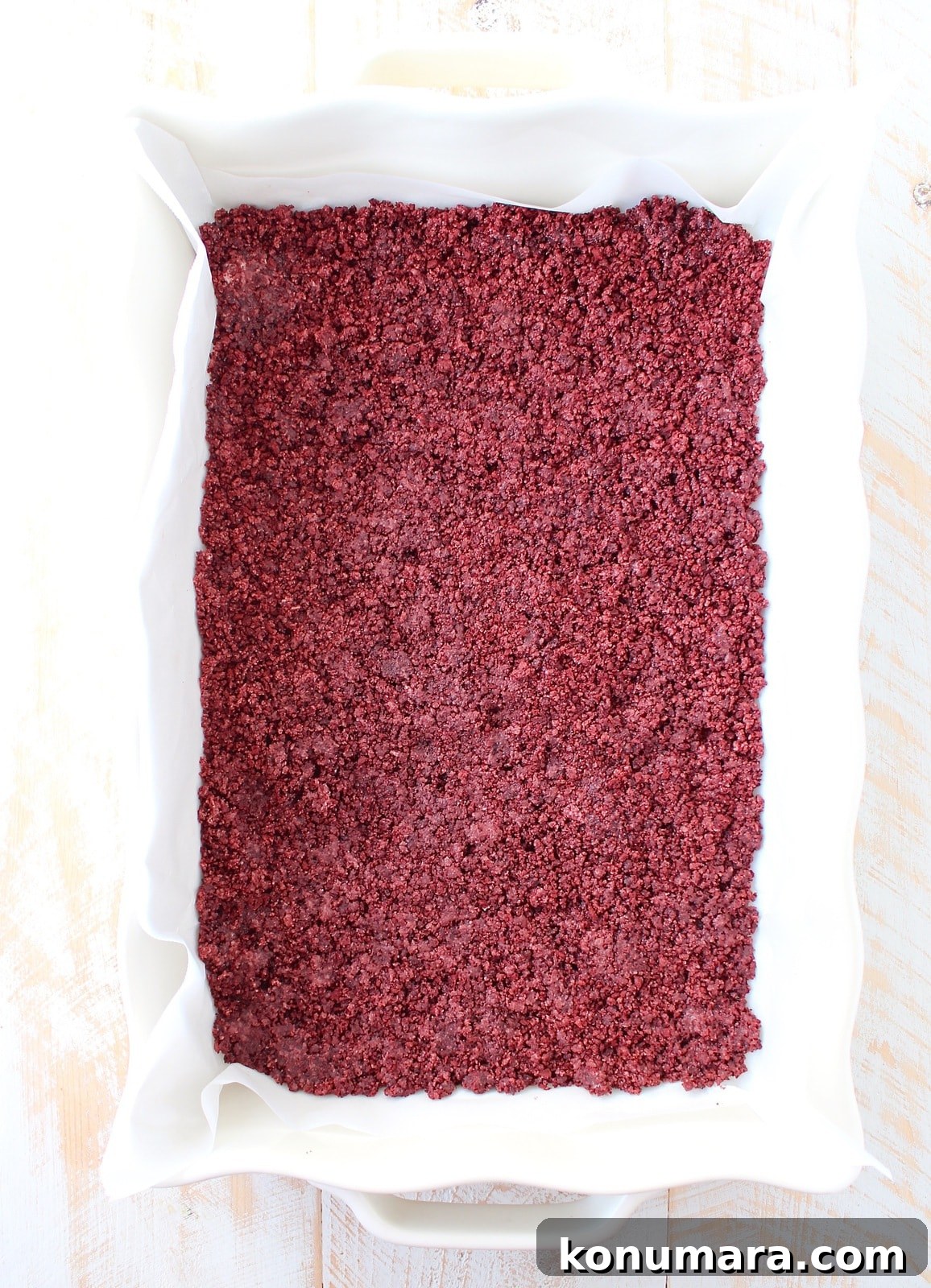 Red Velvet Oreo Cheesecake Bars Recipe 4 crushed red velvet Oreos pressed into a baking dish
