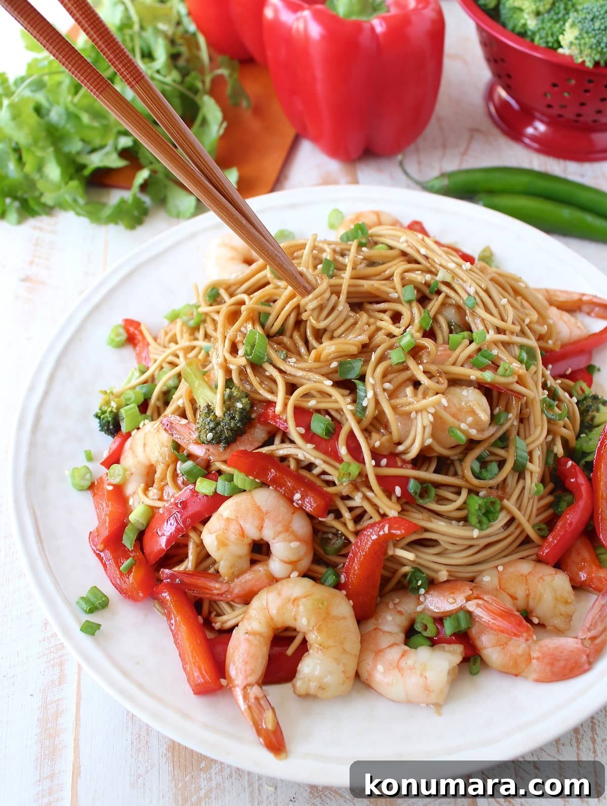 One Pot Teriyaki Shrimp Lo Mein Recipe 9 noodles tossed with shrimp, vegetables and teriyaki sauce on a plate with chopsticks in the noodles