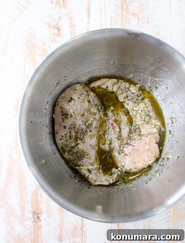 marinating chicken breasts in a metal bowl