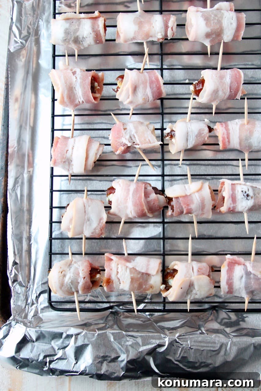 Bacon-Wrapped Dates Appetizer Recipe 4 Uncooked bacon wrapped dates on baking sheet with foil