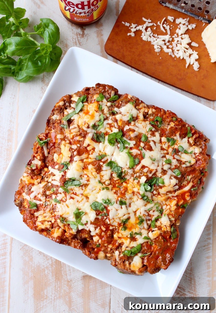 Buffalo-Style Cheesy Meatloaf Recipe 6 cooked cheesy meatloaf on square white plate