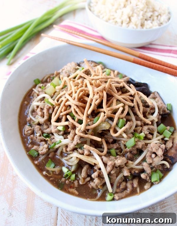 This easy Chinese Pork Chop Suey recipe combines pork, veggies & a delicious Asian sauce, served over white rice, topped with crispy chow mein noodles!