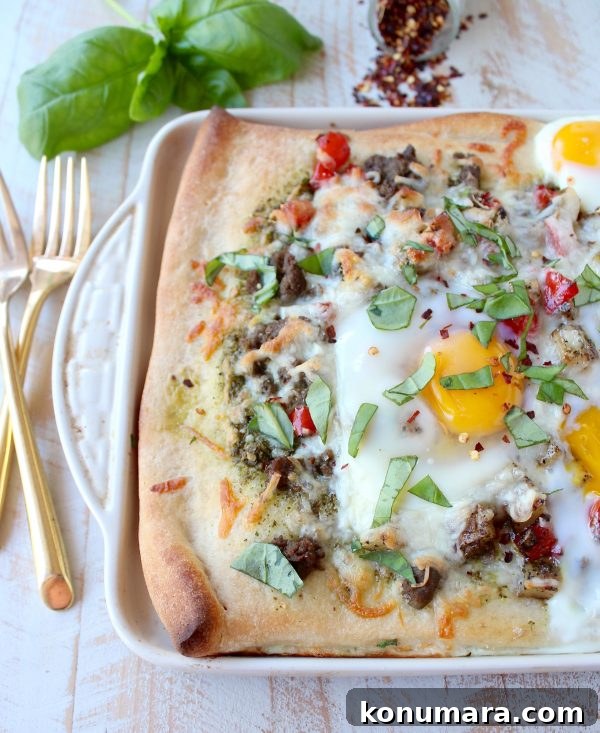 Sheet-Pan Breakfast Pizza Recipe with Eggs and Bacon 2 Breakfast pizza with crispy crust, turkey sausage, sautéed peppers and onions, baked eggs and melted cheese