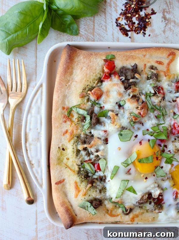 Sheet-Pan Breakfast Pizza Recipe with Eggs and Bacon 4 Sliced breakfast pizza with runny egg yolk and melted cheese