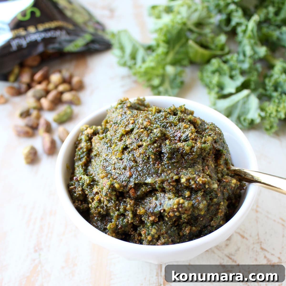 kale pistachio pesto in a bowl with a spoon